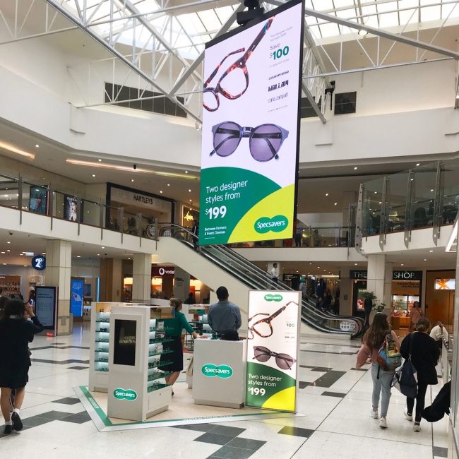 Specsavers pop-up store with large digital banner, designed by Freshpict Creative Solutions